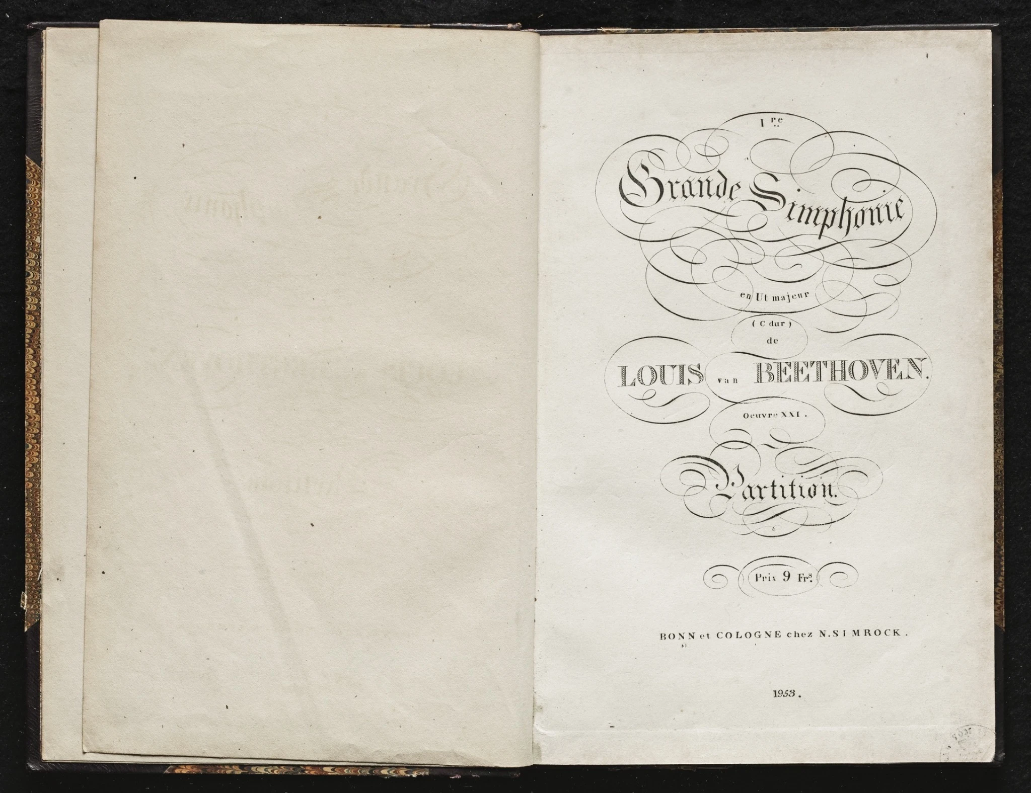 An original printed score of a Beethoven symphony, showing ornate typography and musical notation, representing classical instrumental music and composition.