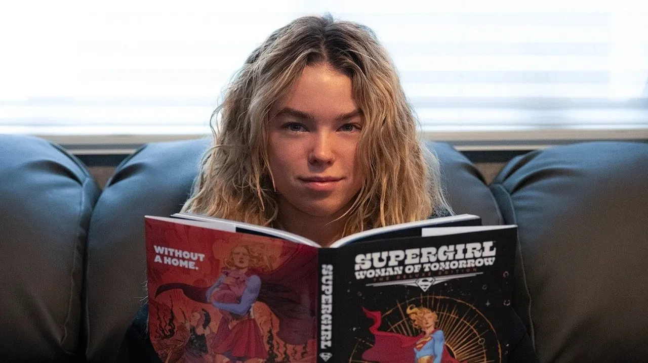 ilm still from Supergirl (2026) showing the character reading Supergirl: Woman of Tomorrow.
