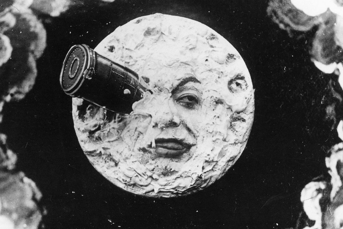 Black-and-white still from the 1902 silent film A Trip to the Moon by Georges Mlis, showing a rocket embedded in the Moon’s face, symbolizing early cinematic fantasy and innovation.