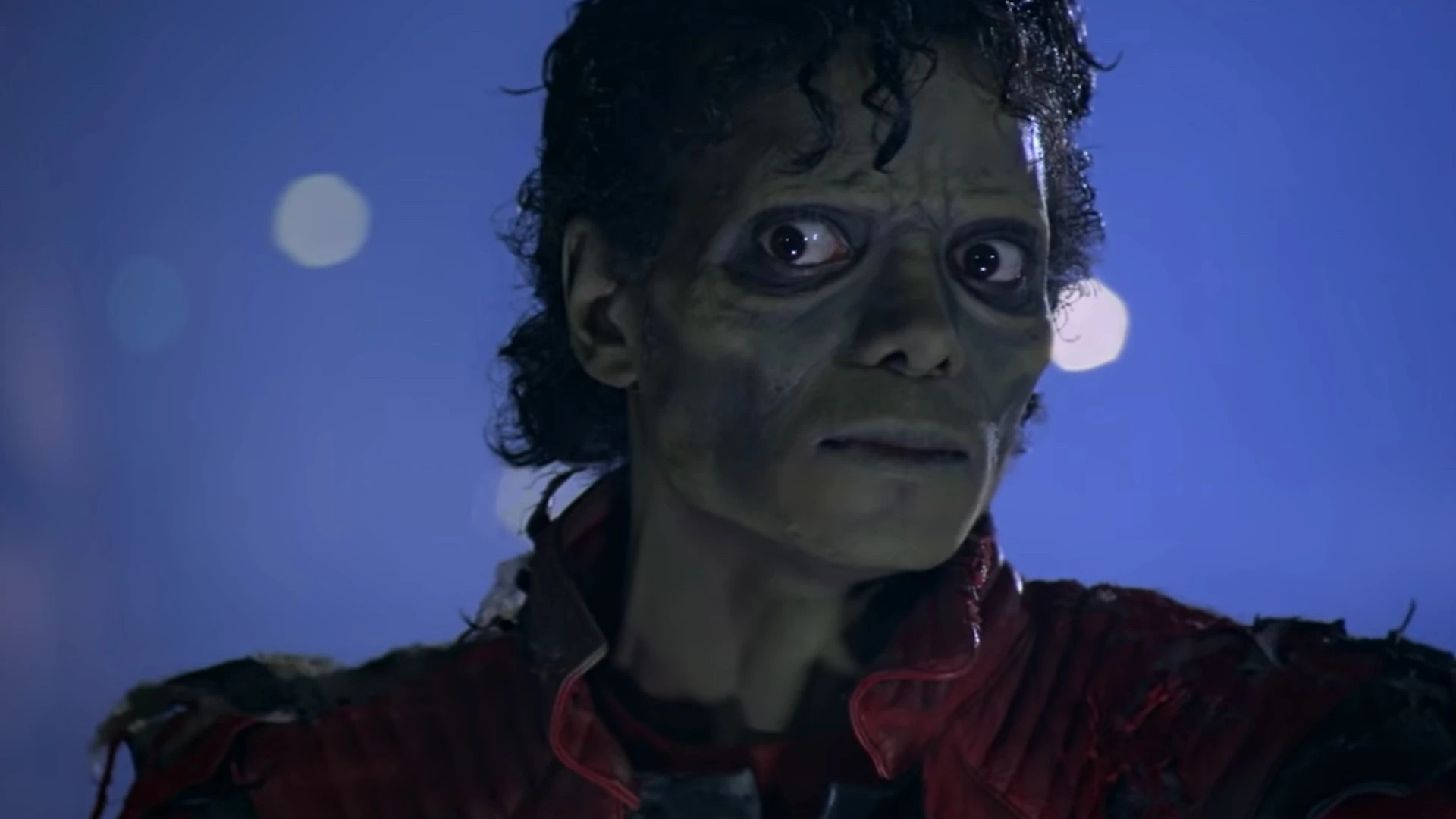 Close-up still from Michael Jackson’s Thriller (1983) showing his transformation into a zombie-like character, referencing classic horror cinema within a short film music video format.