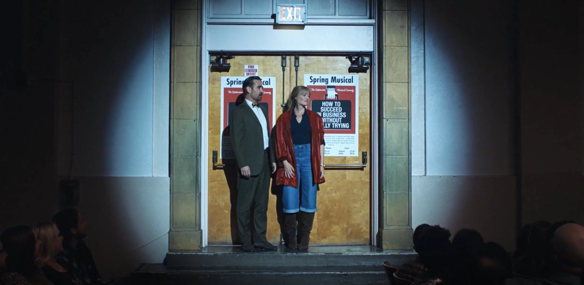 Two characters stand in front of a theater exit door on a stage in a still from A Big Bold Beautiful Journey (2025), directed by Kogonada.