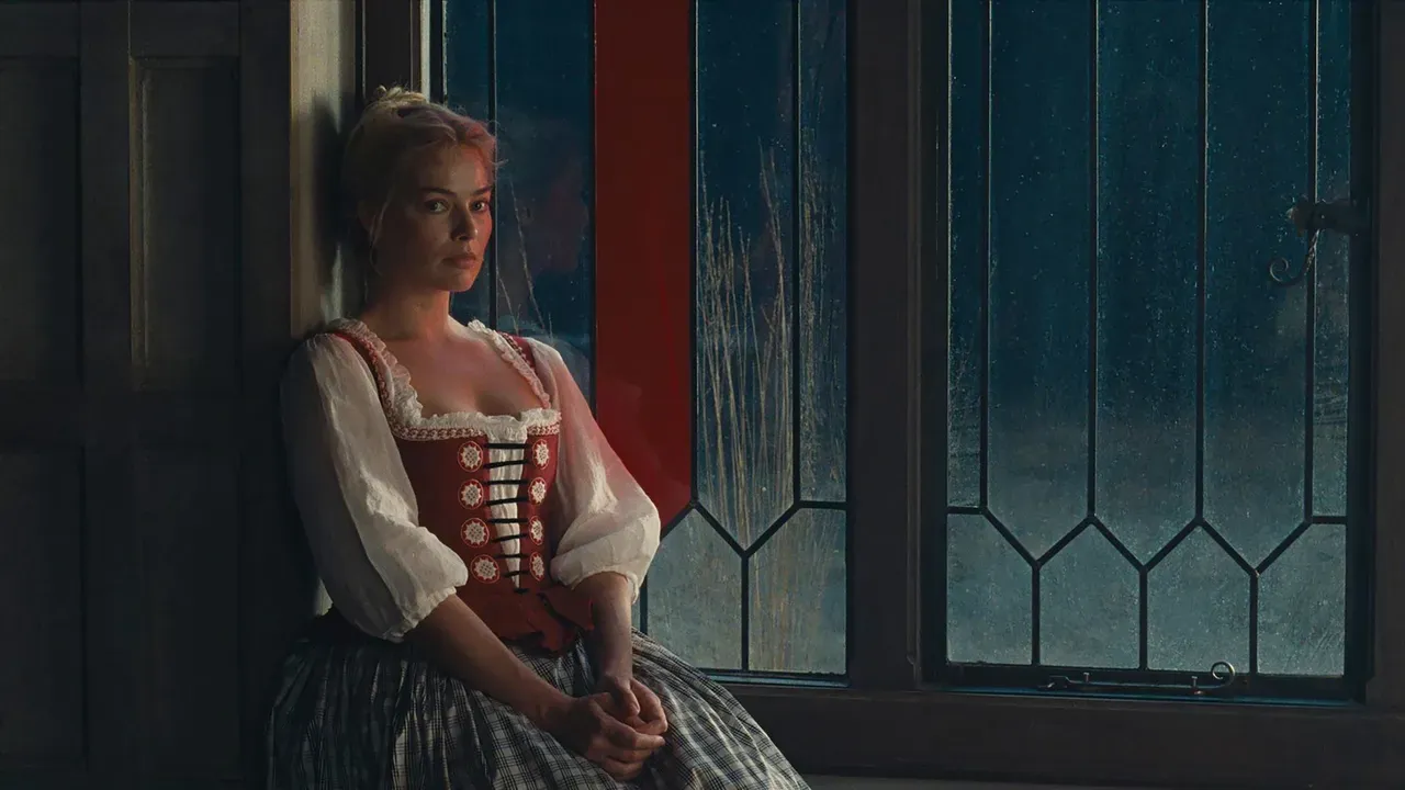 Catherine Earnshaw sits by a leaded glass window in a cinematic still from Wuthering Heights, wearing a cottagecore inspired dress reminiscent of a traditional German milkmaid style, softly lit in a moody period interior
