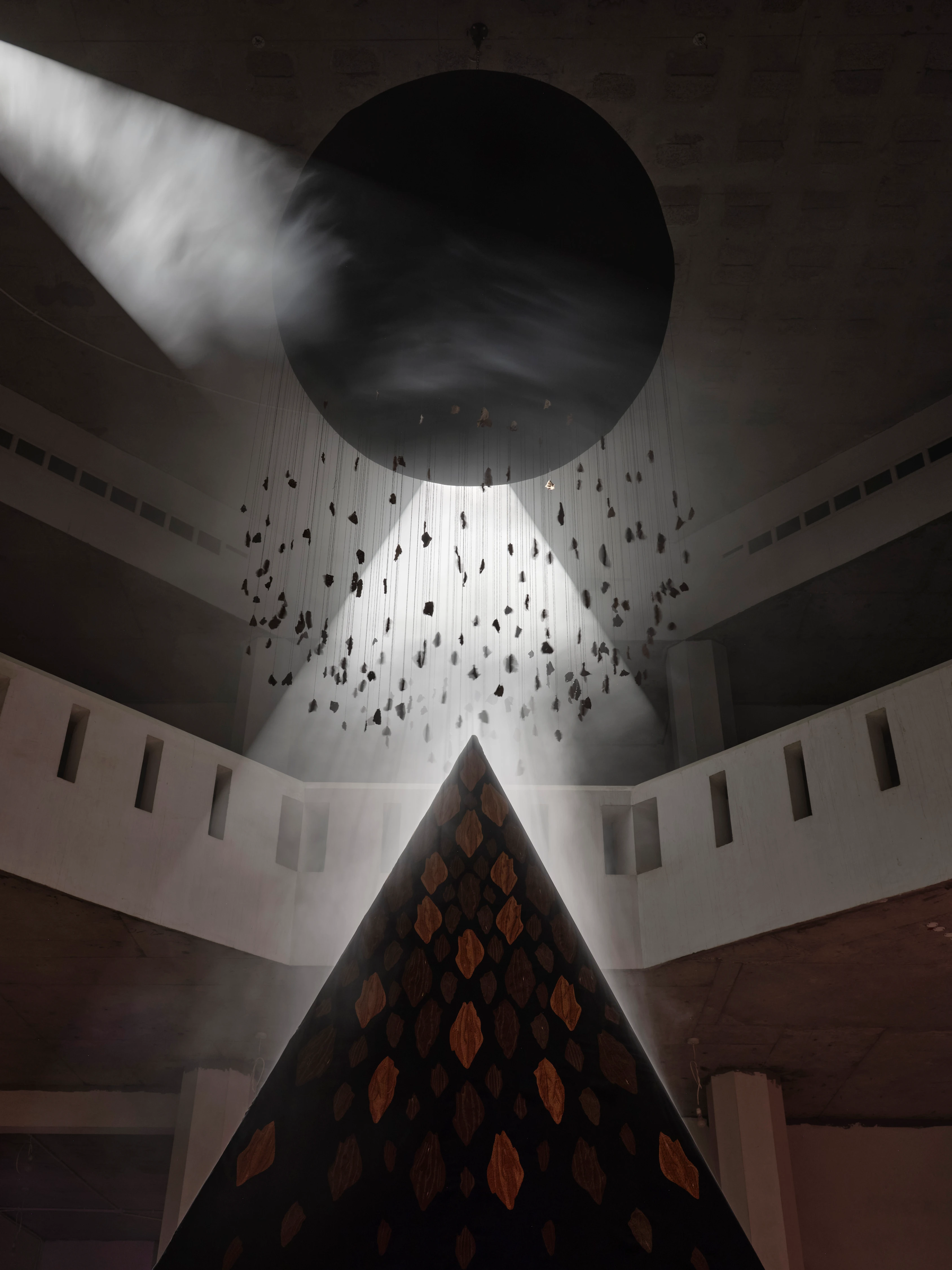 Departed Soul Incense Burner installation, ASBAR series: dark sphere suspended above illuminated pyramid with hanging fragments