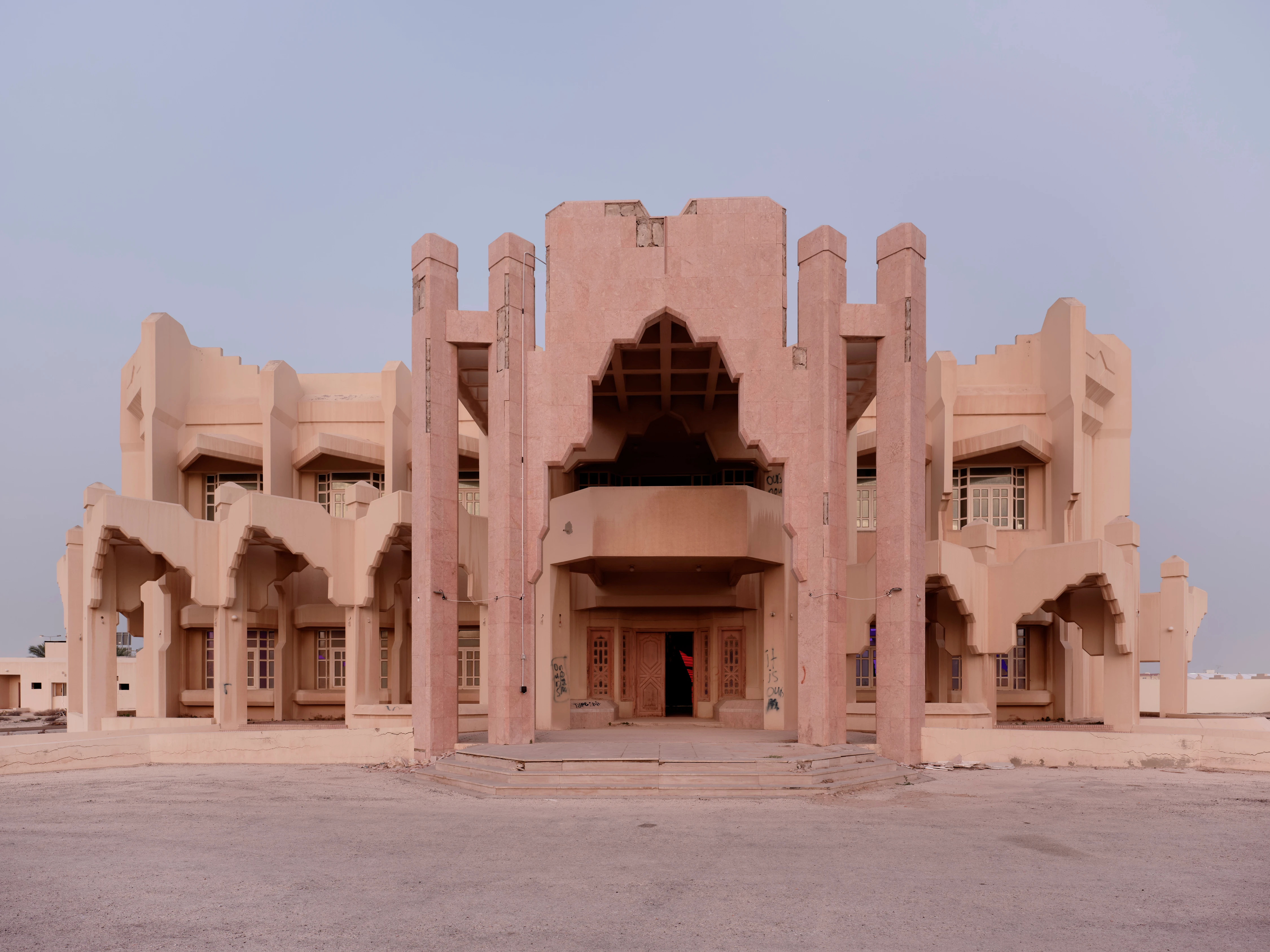 ASBAR 2026 abandoned pink modernist palace with Islamic arches in arid desert landscape, photo by Eva Herzog