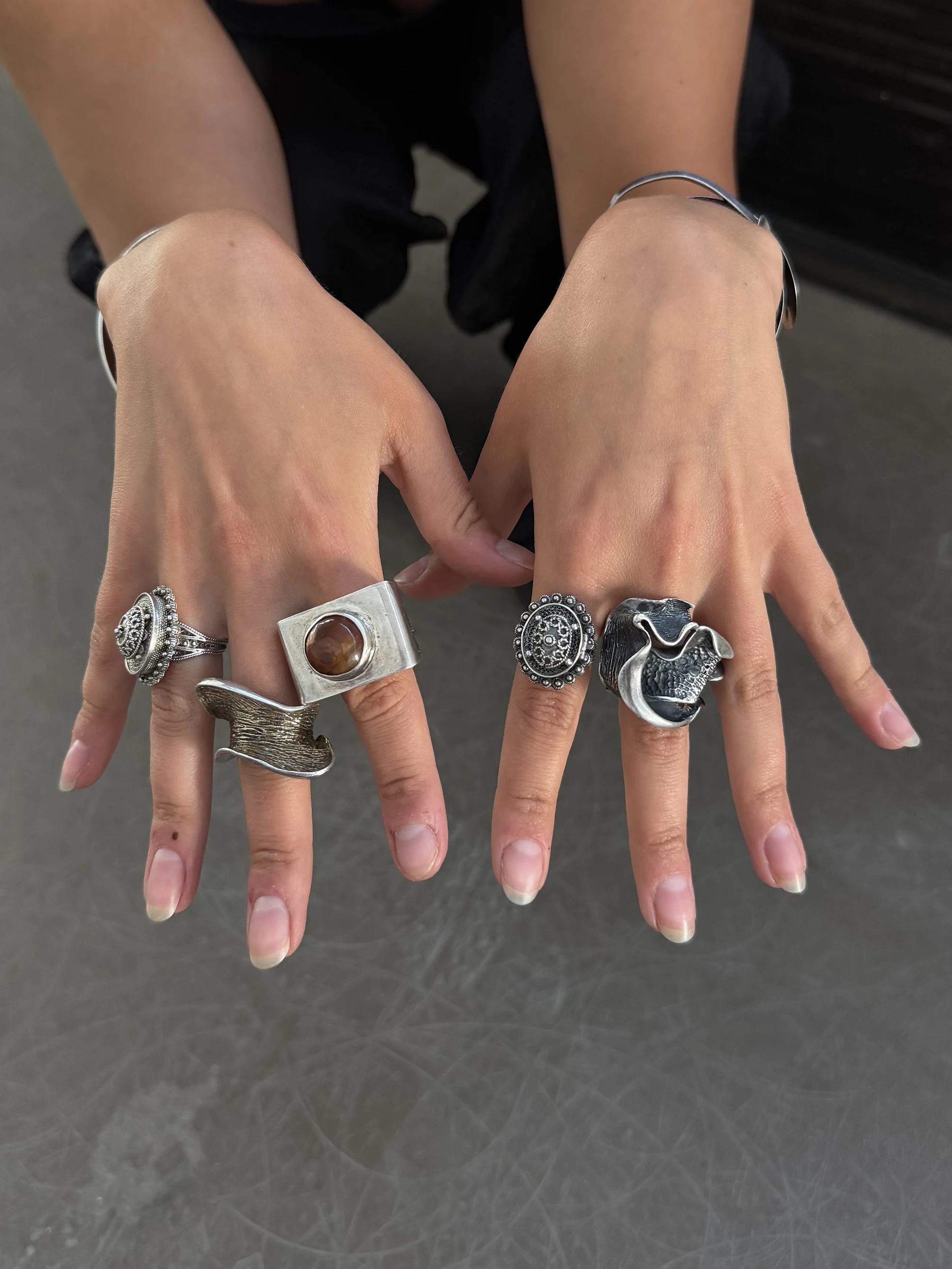 GIUNIA sterling silver statement rings styled on hands with French manicure, bold sculptural jewelry collection
