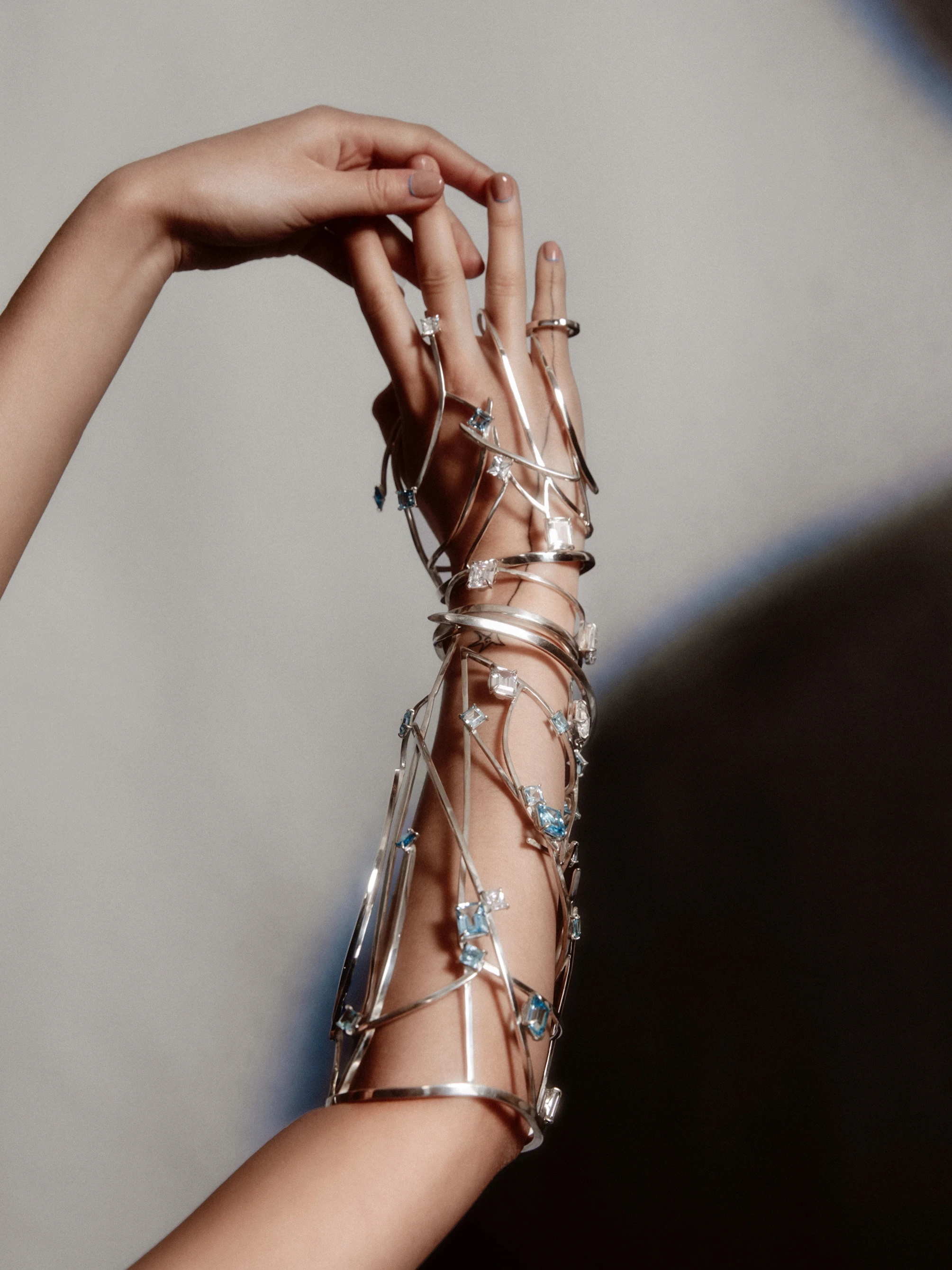 Sweet Line Juice Interstellar Armour sculptural silver wire arm cuff with aquamarine crystals wrapping forearm and hand