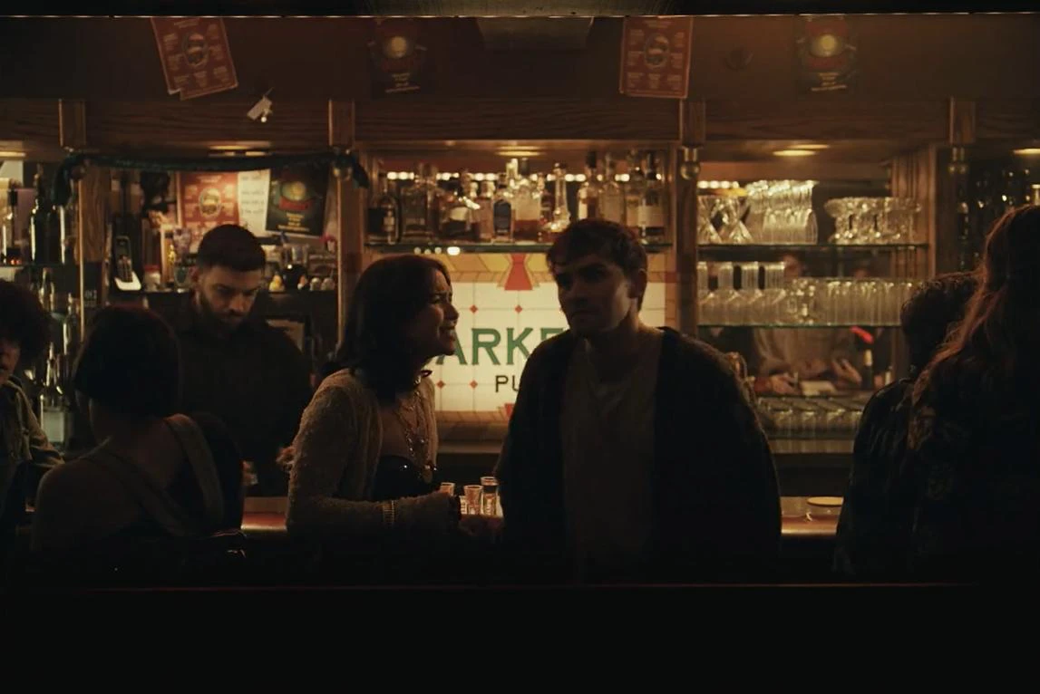 Sarah and Bear share an intimate conversation at Barker's Pub in Focus Features' Obsession
