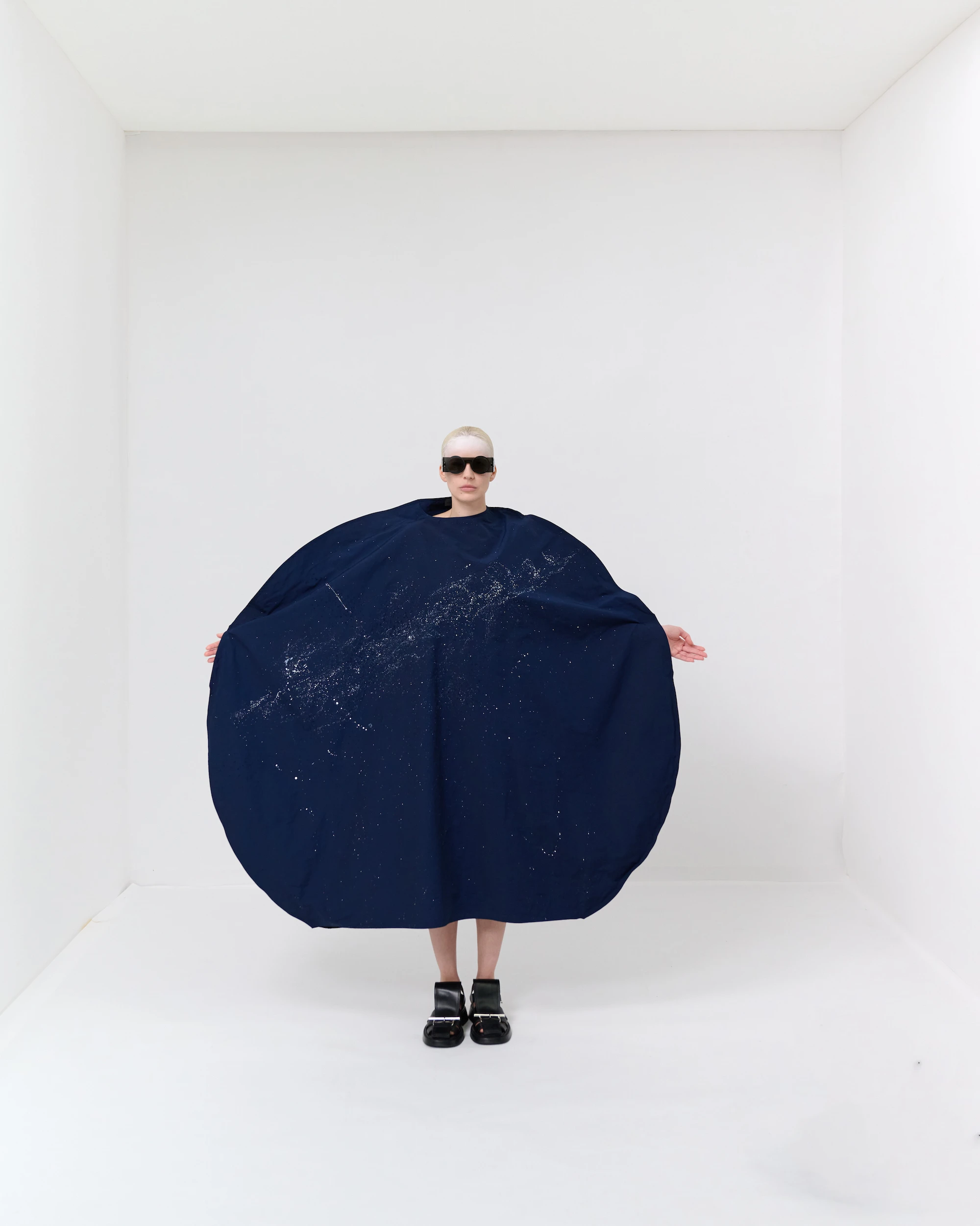 Maria Calderara SS26 Via Lactea oversized navy circular cape dress with crystal constellation embroidery, white studio