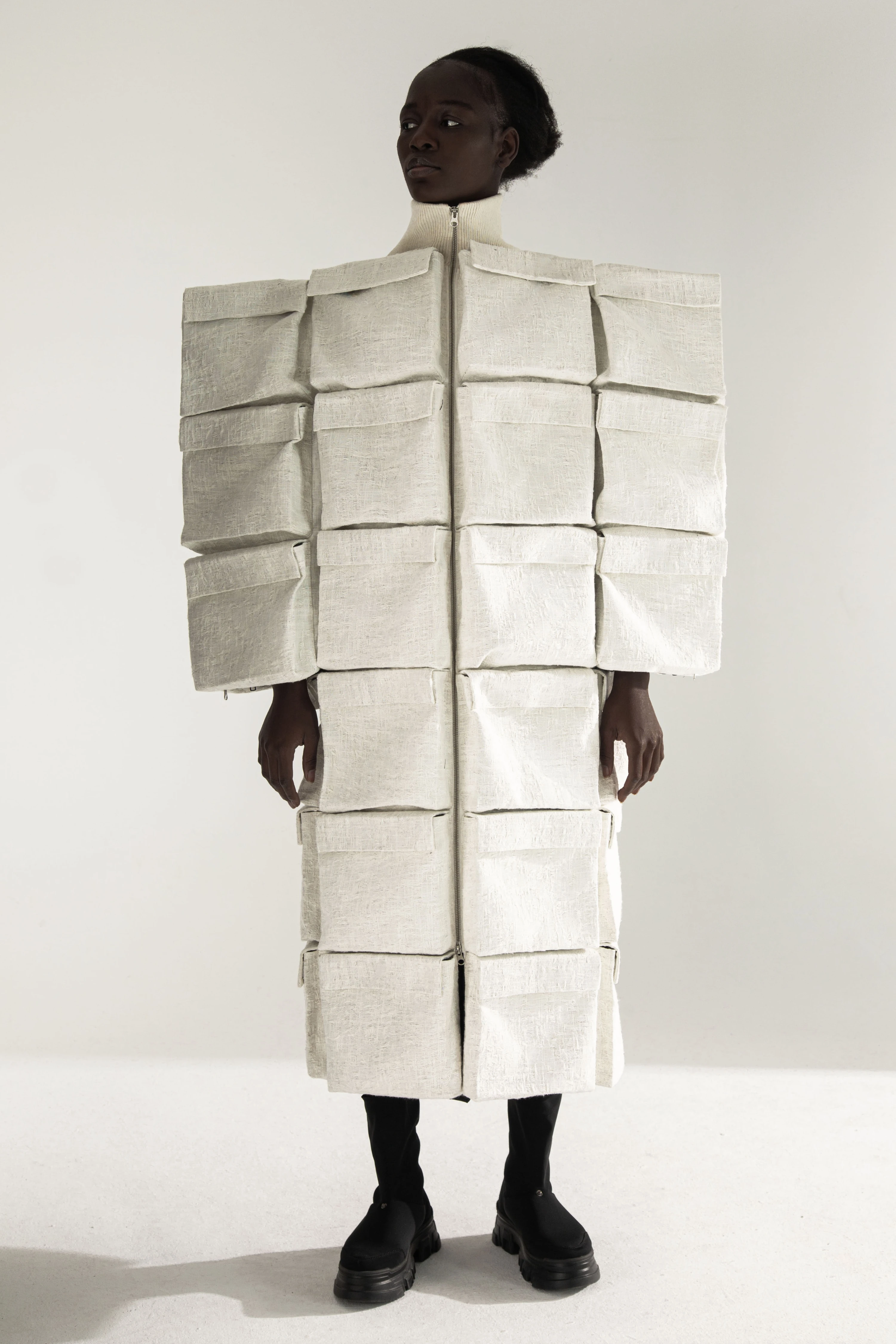 DZHUS TRANSIT AW23 sculptural linen coat with geometric padded squares, modular avant-garde fashion by Ganna Goncharova