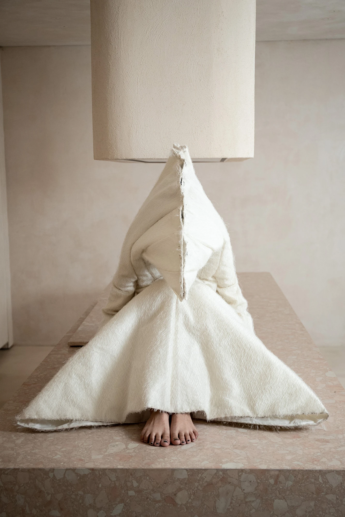 DZHUS ANTICON collection sculptural white textile ensemble with pointed hood, bare feet, at CONCEPT 11 Warsaw