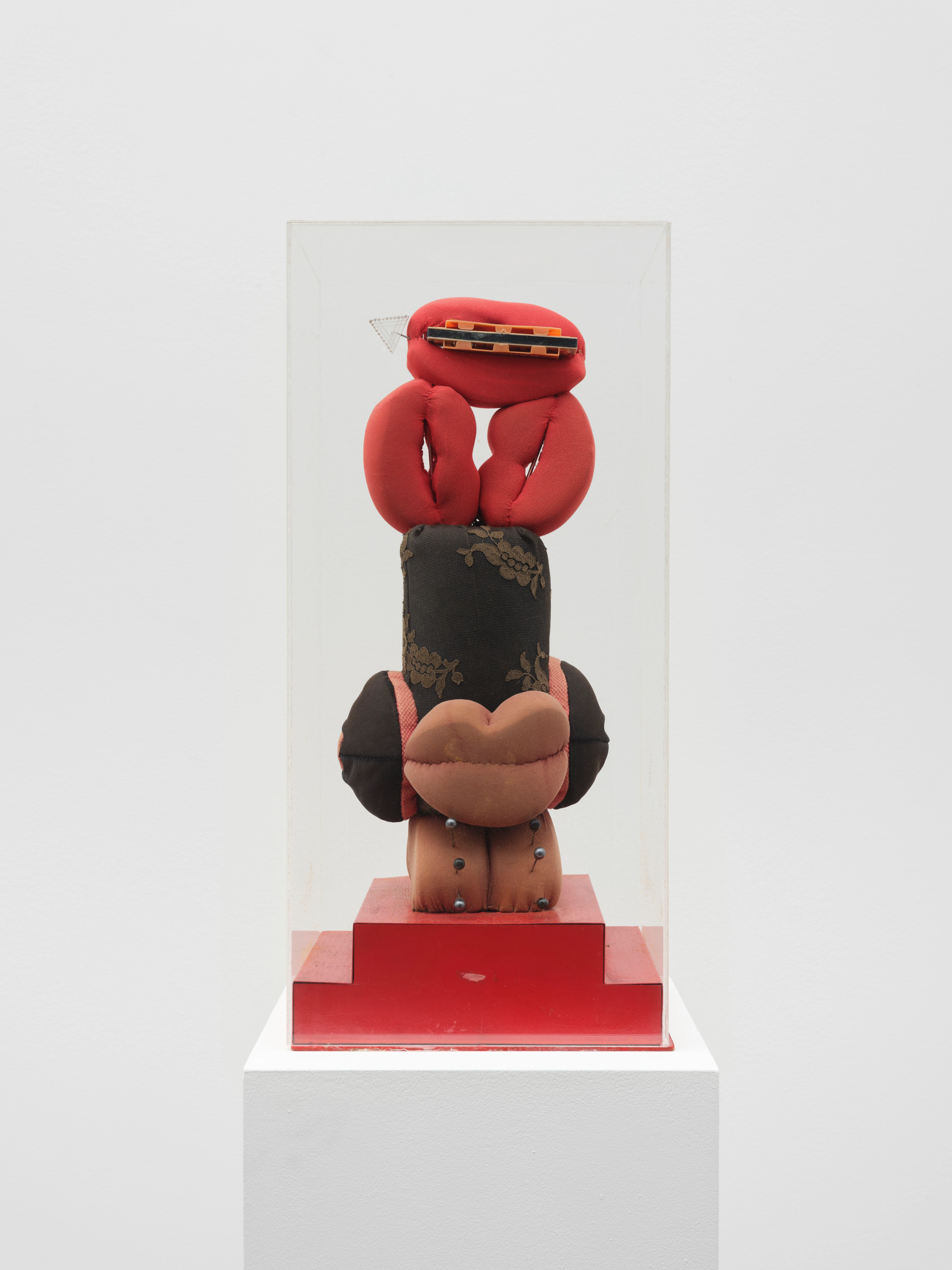 Clemen Parrocchetti, Liberazione 1974, stacked textile sculptural totem with red forms and lips in acrylic case
