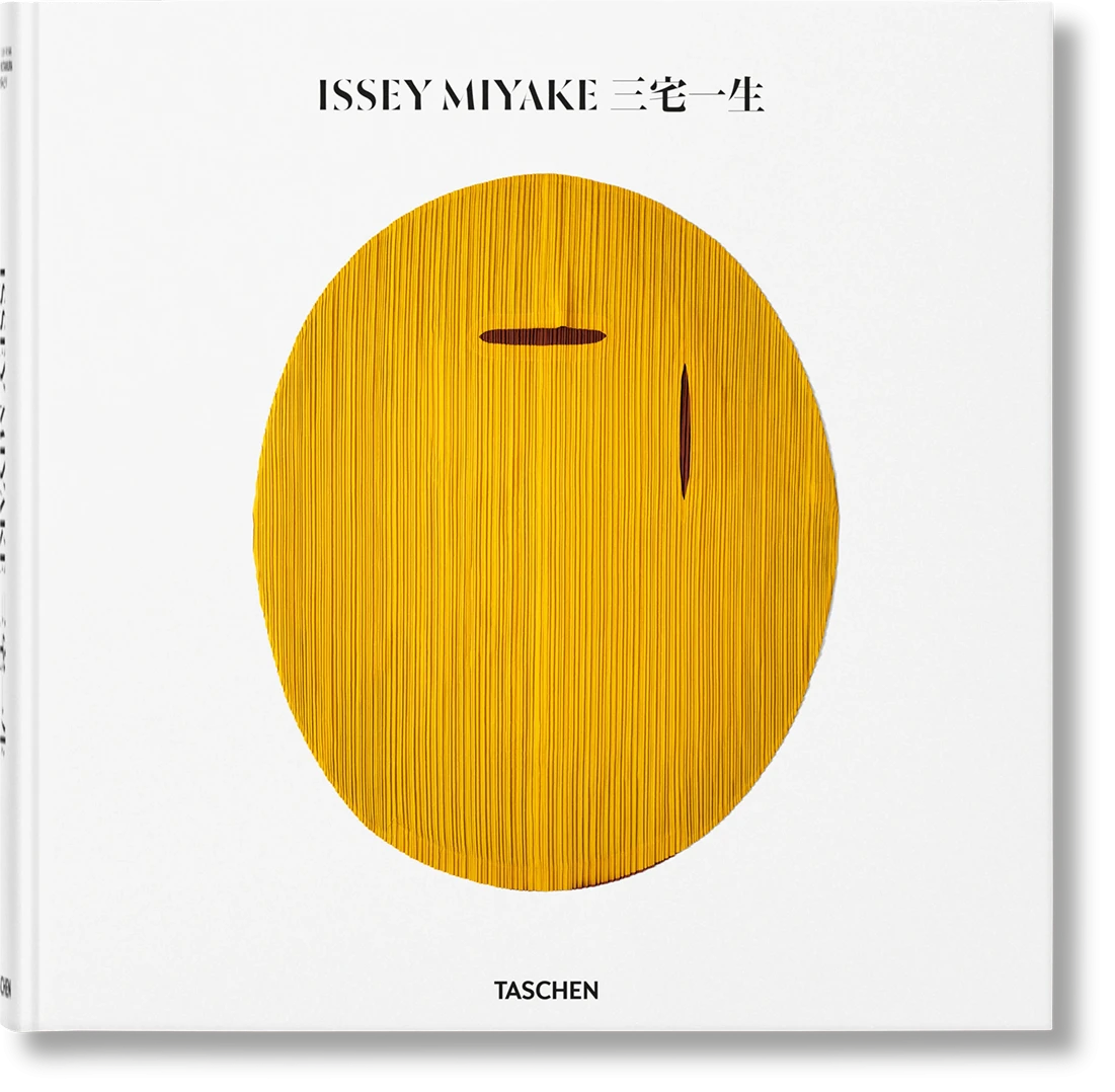 Issey Miyake Taschen monograph cover featuring a golden textured oval sculpture on white background