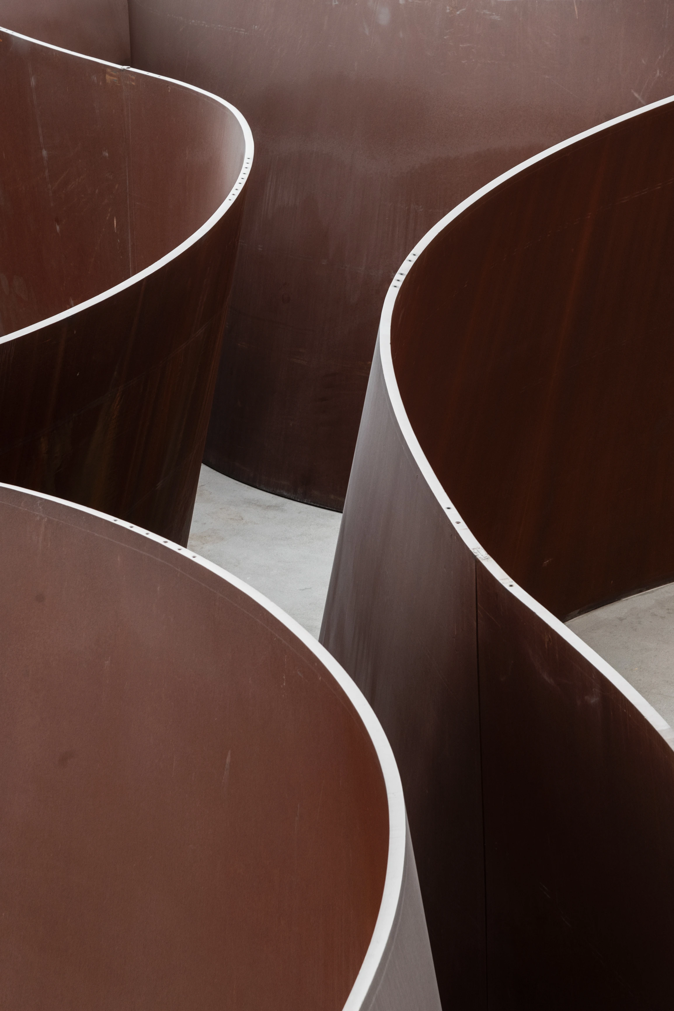Richard Serra weathered steel sculpture with sweeping curved Cor-Ten walls creating labyrinthine passageways