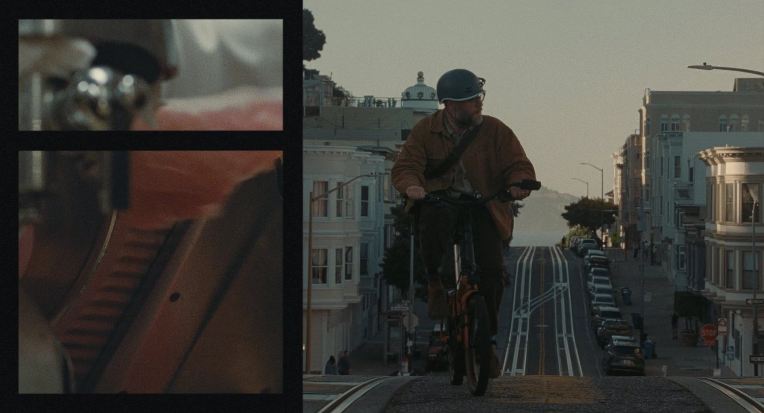 Seth Rogen as Joe cycling down a steep San Francisco street in The Invite, an A24 film