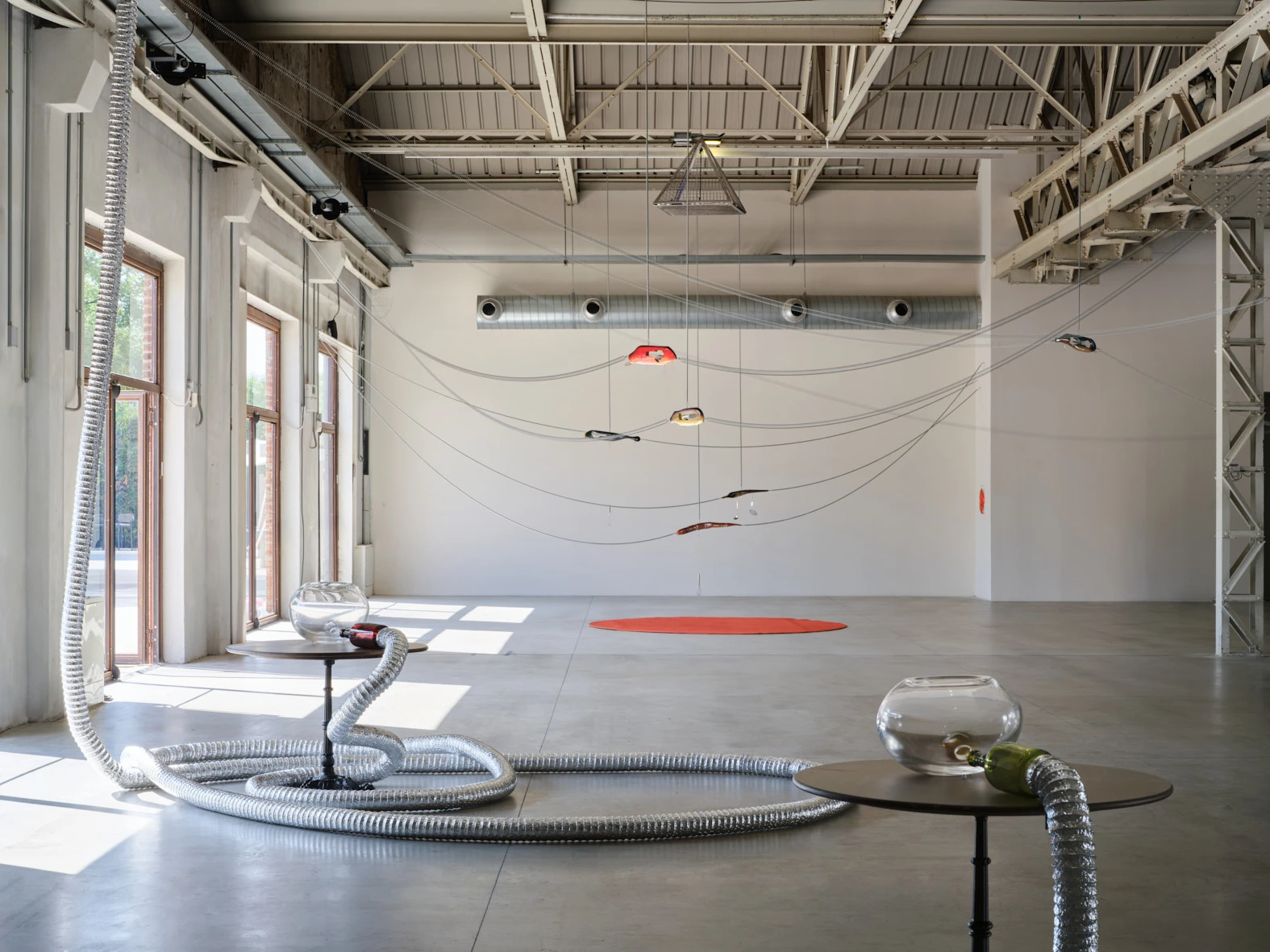 Aki Sasamoto XYZ installation view at Pirelli HangarBicocca Milan with suspended cables, metallic ducts, and glass bowls