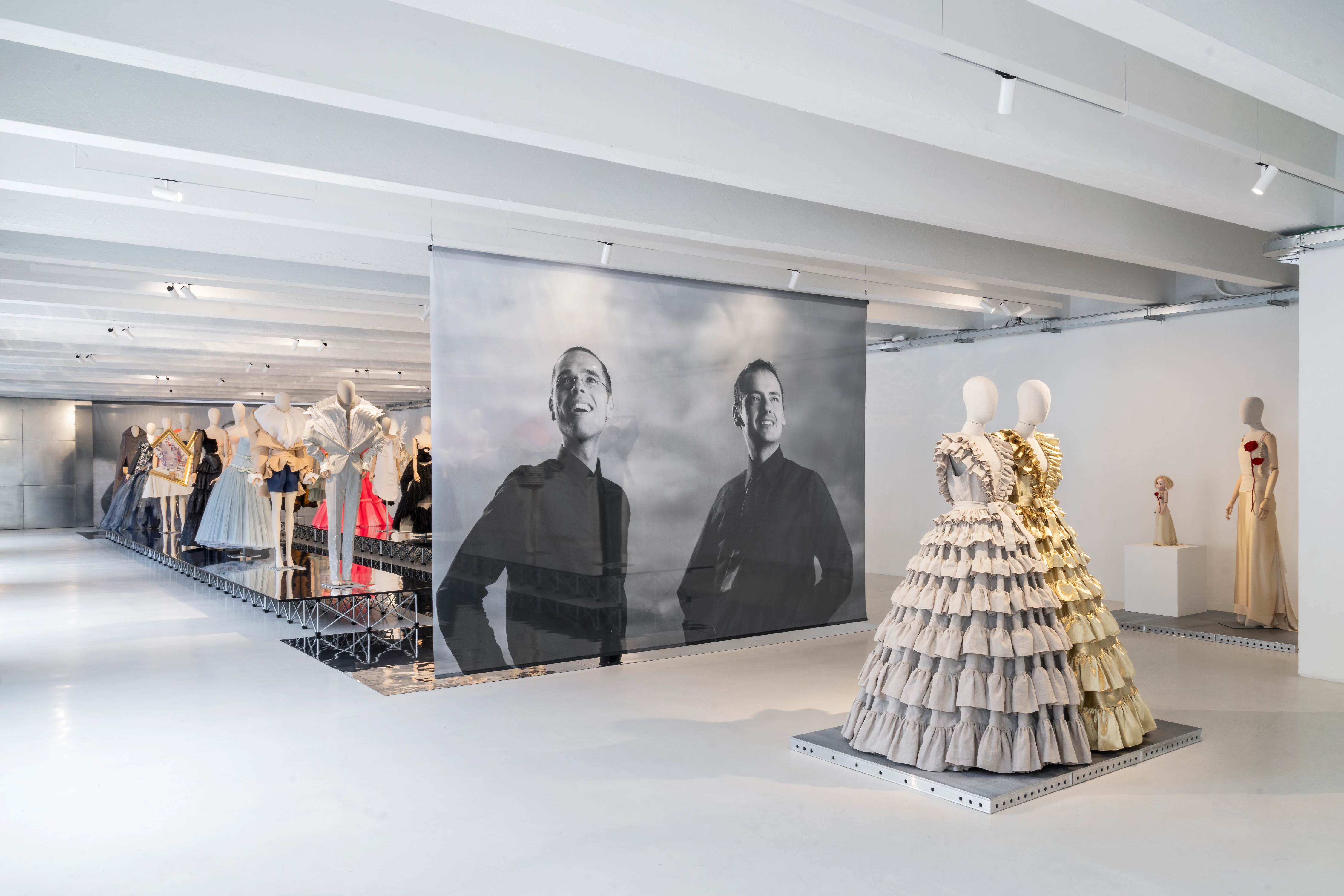 Viktor&Rolf Spectrum installation view at 10 Corso Como Milan, featuring tiered sculptural gown and large-scale portrait photography