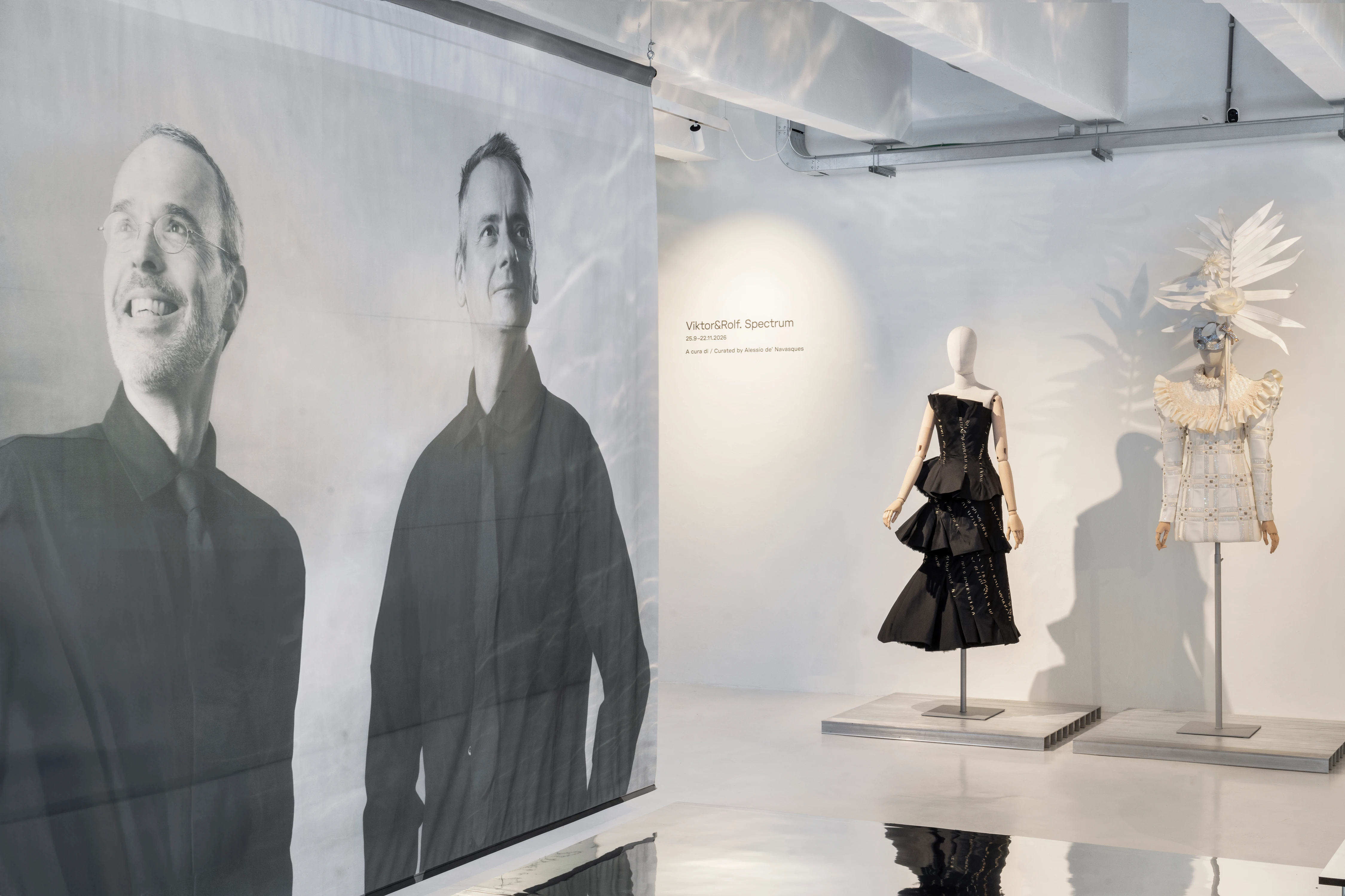 Viktor&Rolf Spectrum installation view at 10 Corso Como Milan featuring black sculptural gown and white feathered costume on mannequins