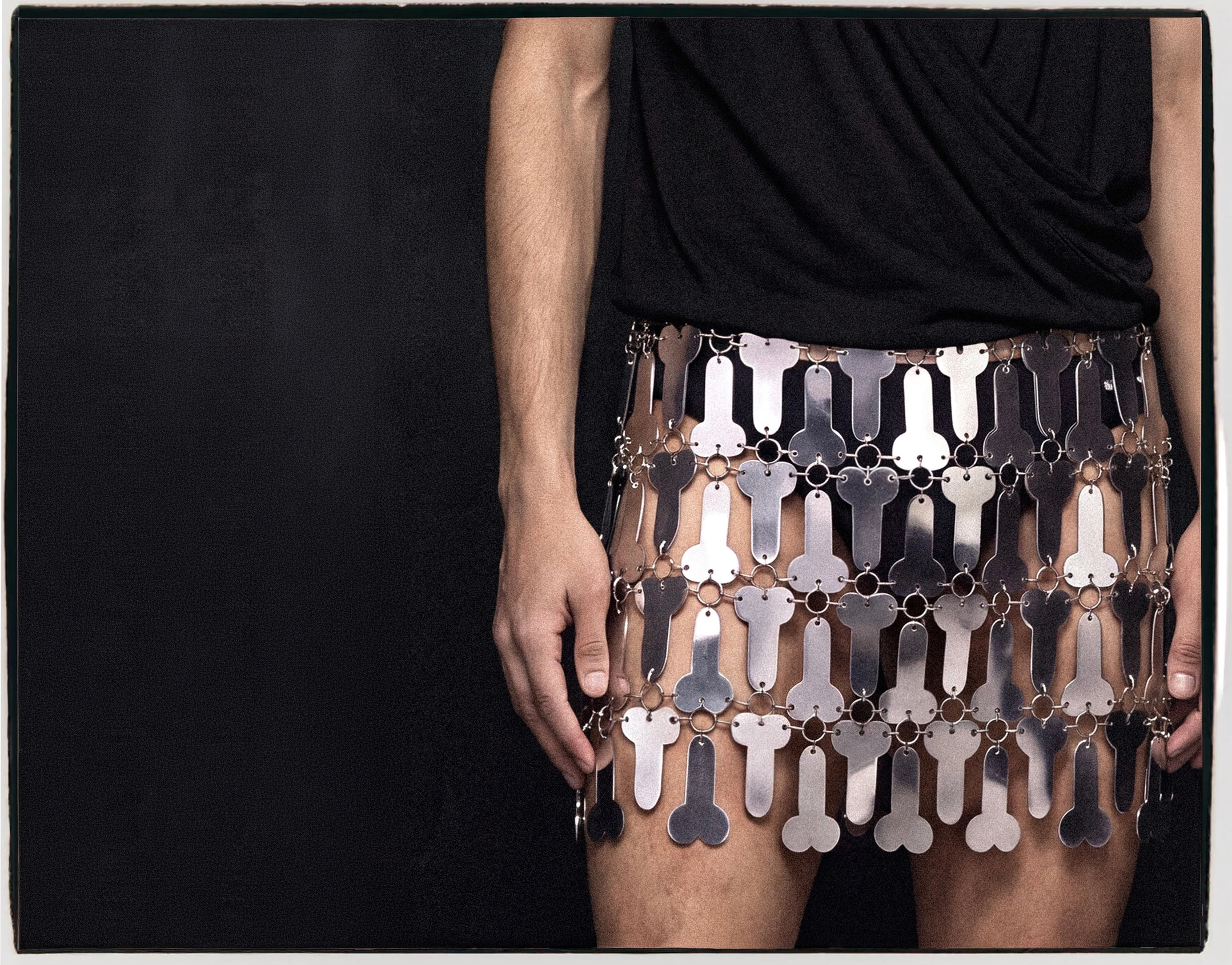 Goksenin Ay Lament debut collection metal chain-link mini skirt with phallic motif panels, styled with black top