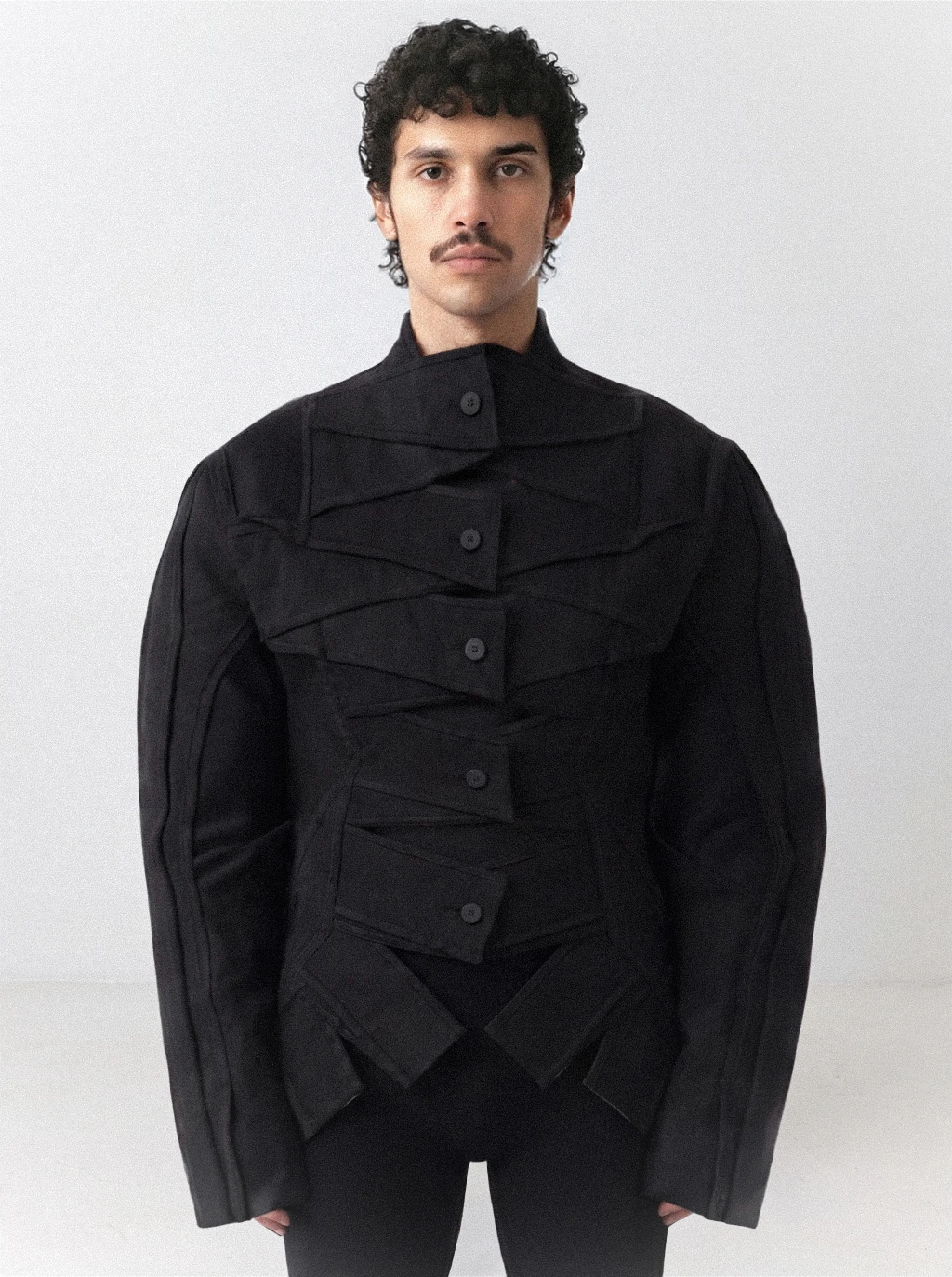 Goksenin Ay debut collection Lament: structured black jacket with geometric woven strap detailing and high collar