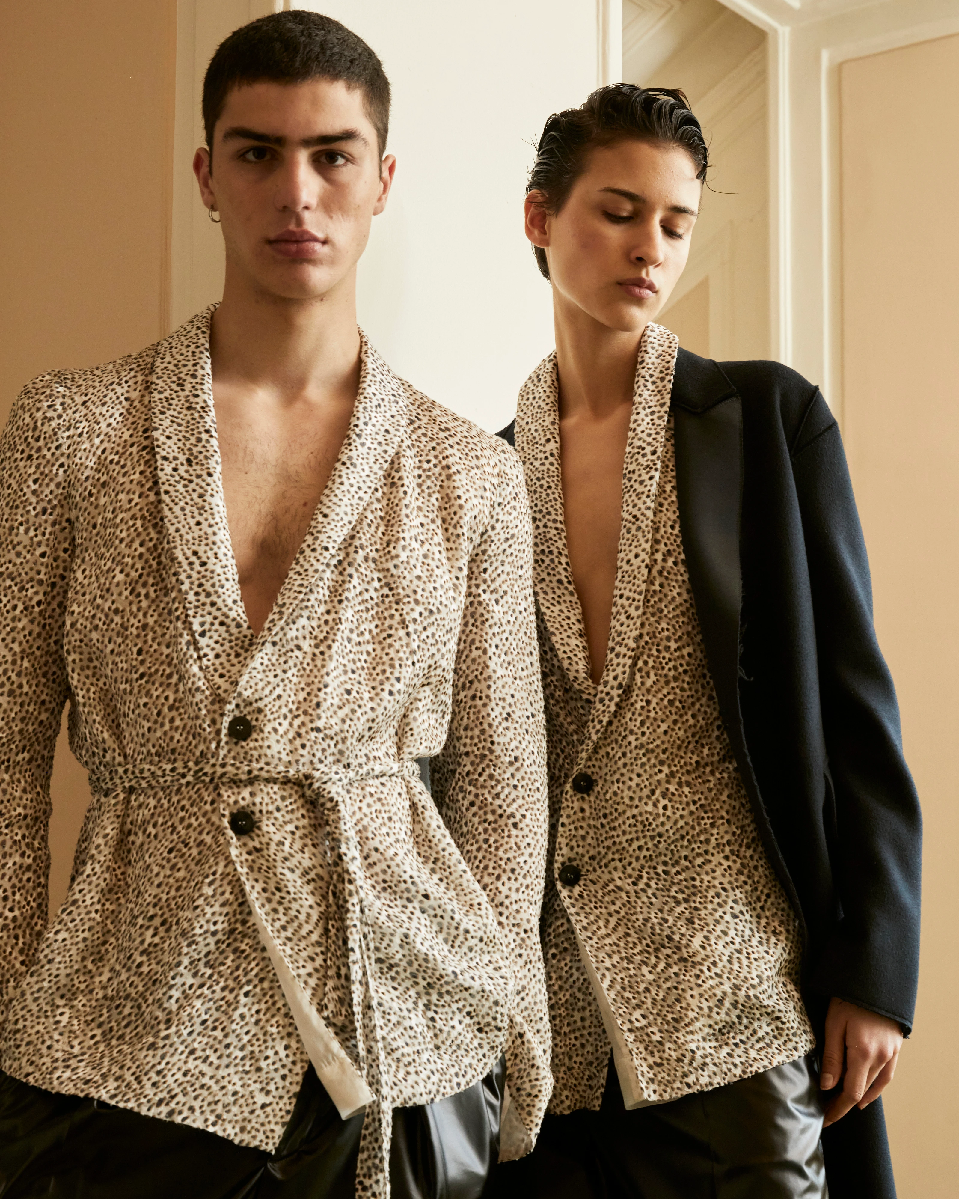 SAPIO FW25 two models wearing matching leopard print blazers, one layered under a black oversized jacket