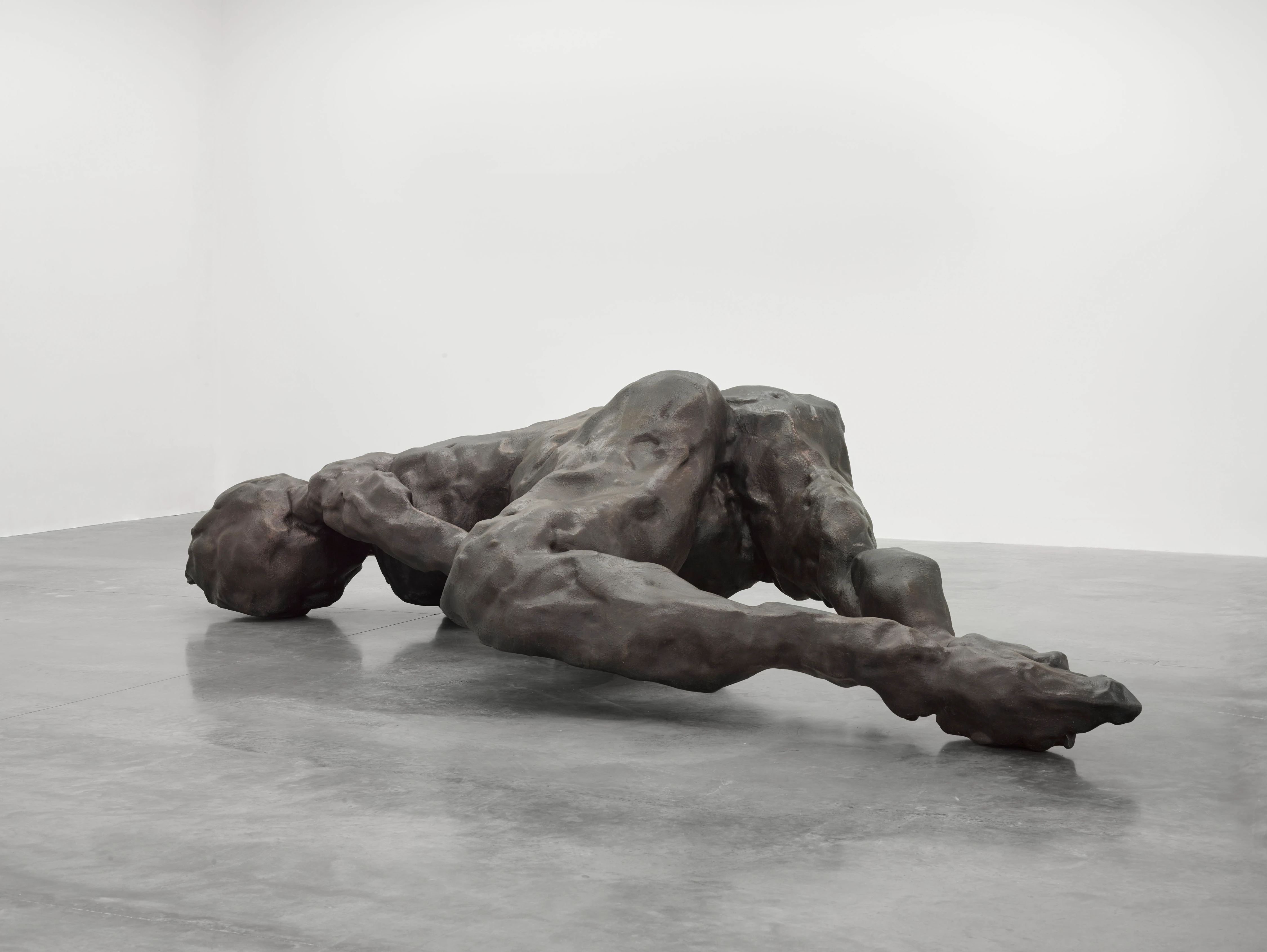 Tracey Emin, I Lay Here for You, 2018 — large bronze sculpture of a reclining human figure on gallery floor