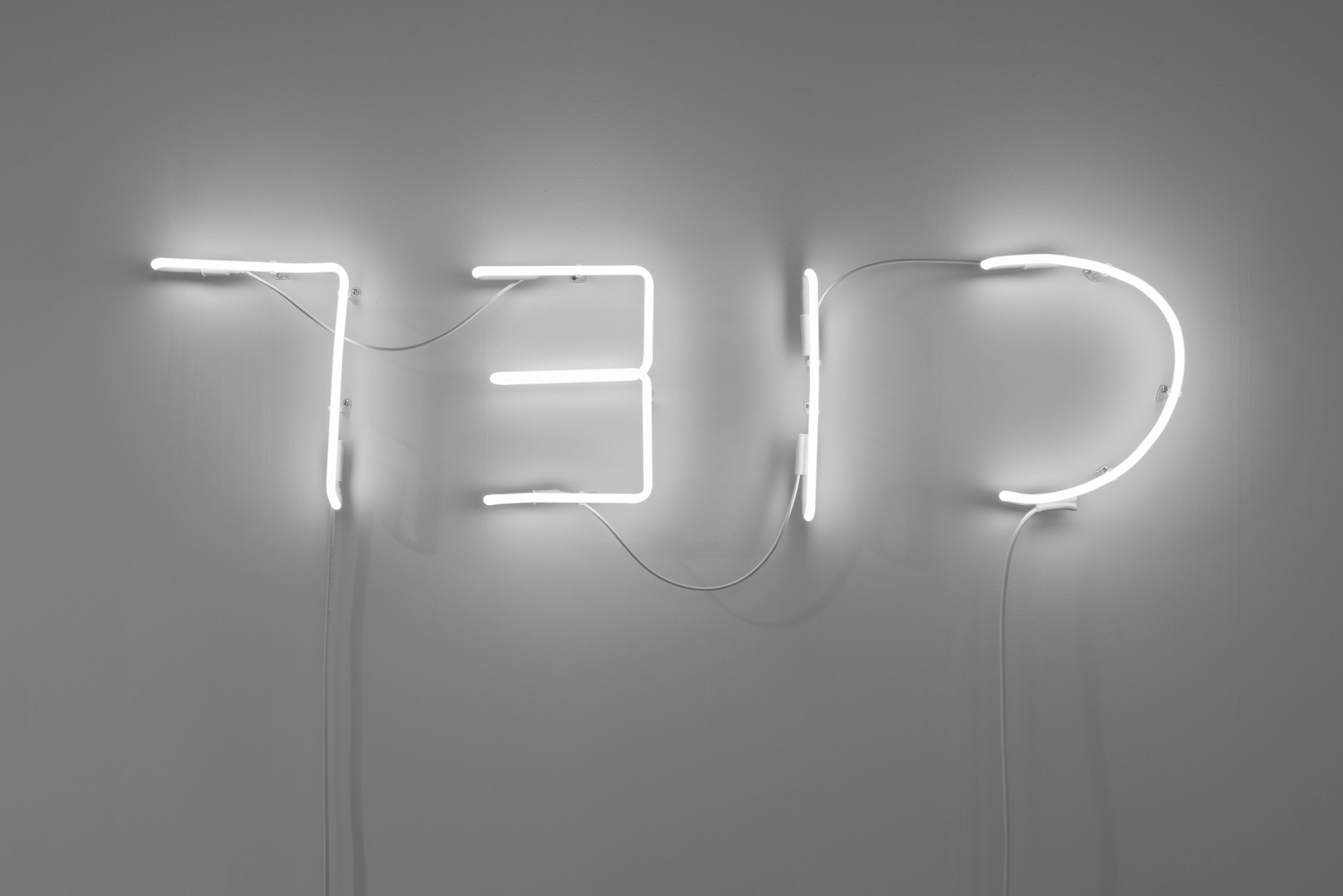 Marcello Maloberti CIEL 2023 white neon sculpture spelling reversed letters on gray wall, courtesy Raffaella Cortese Milan