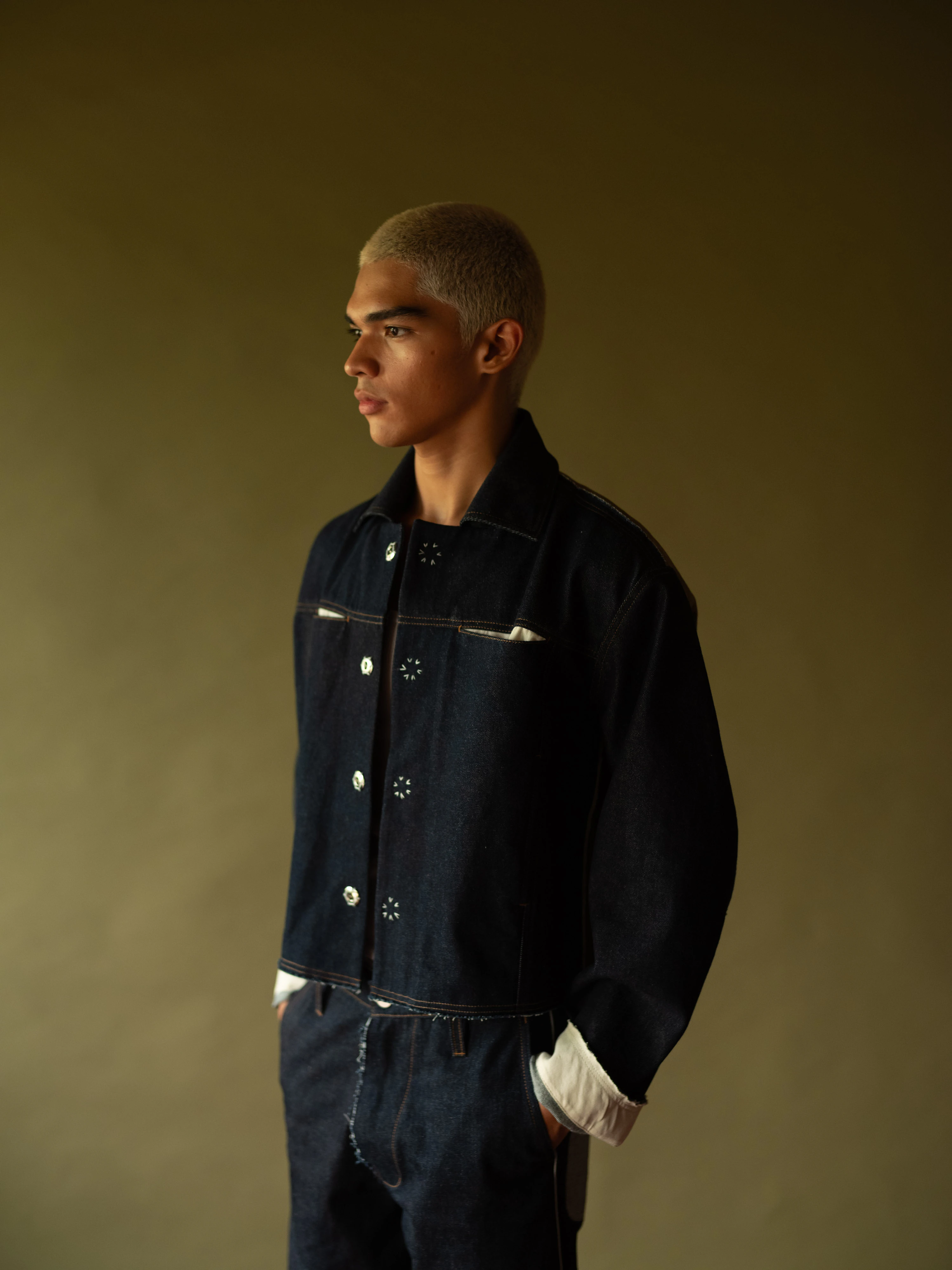BAGASAO dark indigo denim jacket with contrast stitching and snap buttons, styled with matching jeans